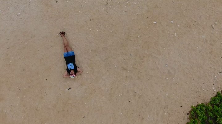 laying in the sand at sandy beach drone videography by @maxkiesler