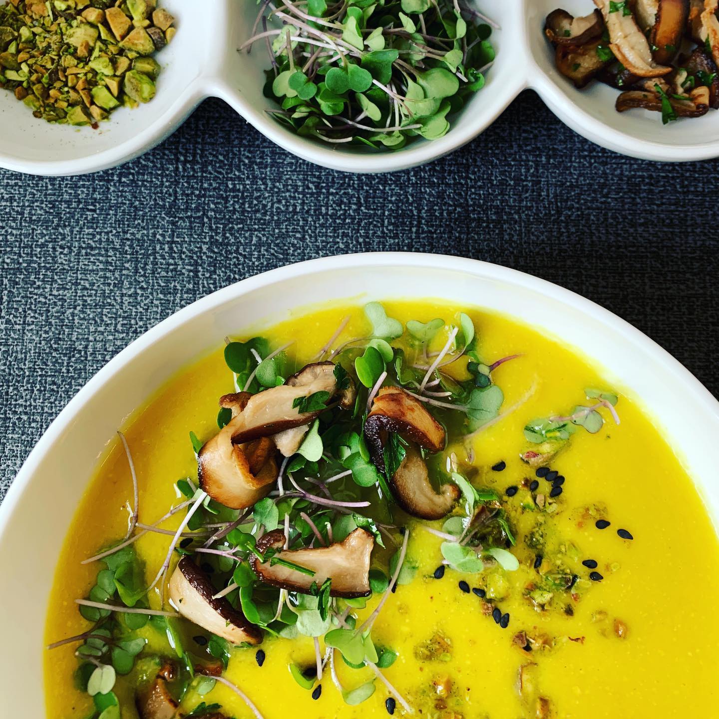 Celebrating turmeric and cauliflower soup with shiitake mushrooms, micro kale and crushed pistachios. Soup by @maxkiesler