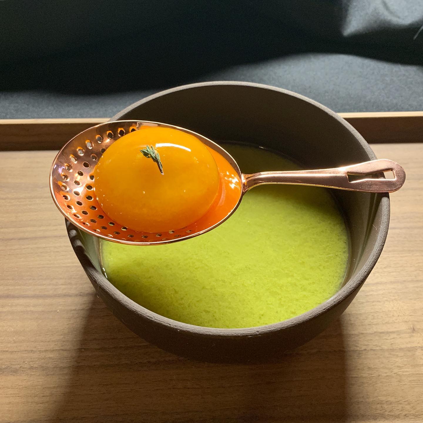 Our new soup sphere series: spherical Moroccan carrot soup with sweet pea and mint. The sphere is liquid soup!